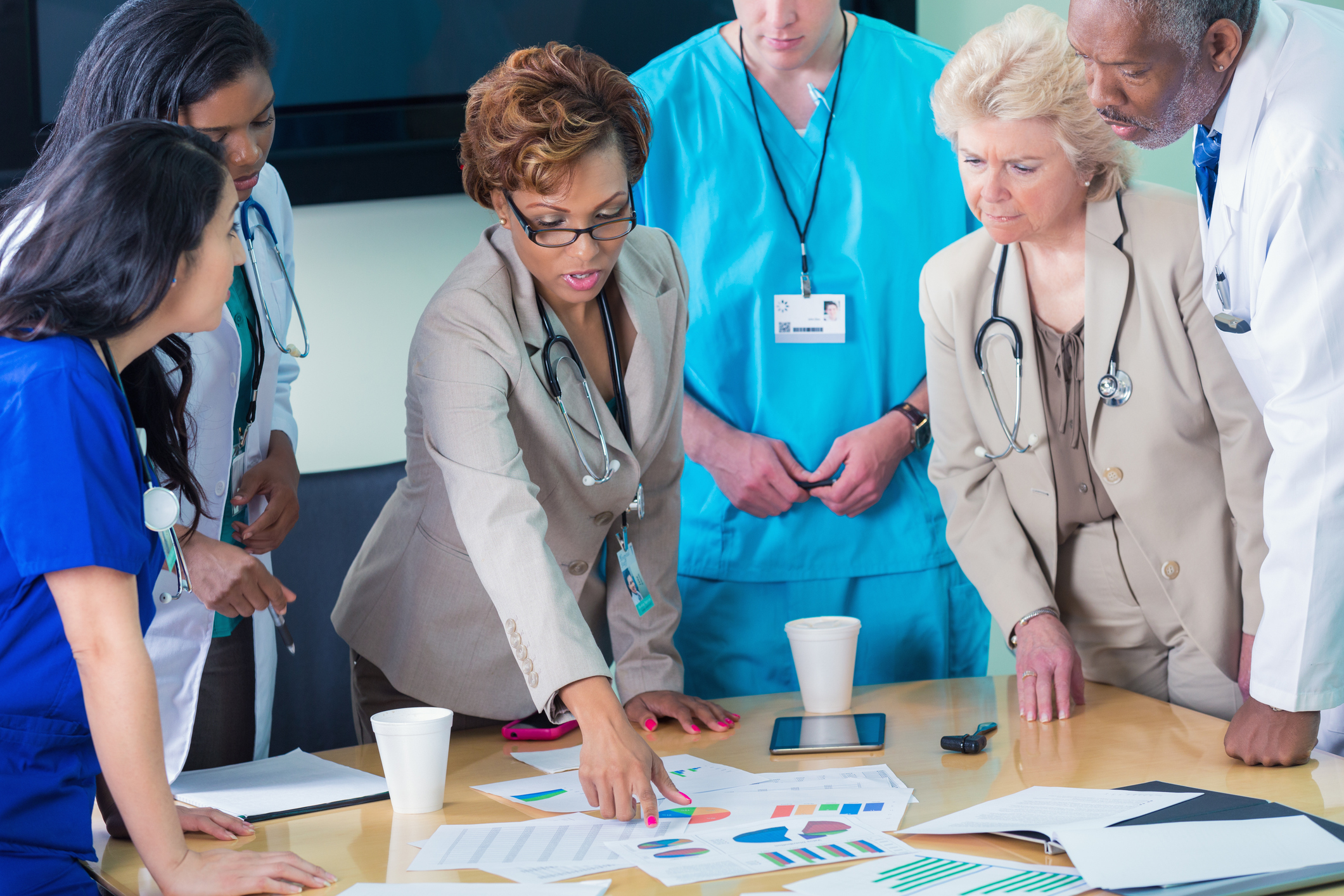 Diverse medical team or board reviewing hospital financial information